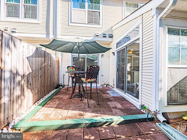 a table and chairs in patio of the house