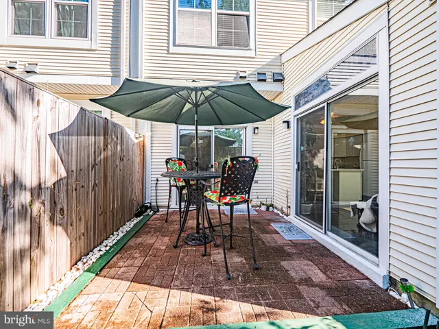 a view of a yard with wooden fence