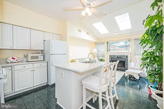 a kitchen with kitchen island a sink appliances and cabinets