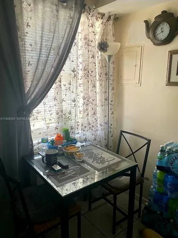 a view of a dining room with furniture and window