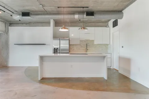 a kitchen with a sink cabinets and stainless steel appliances