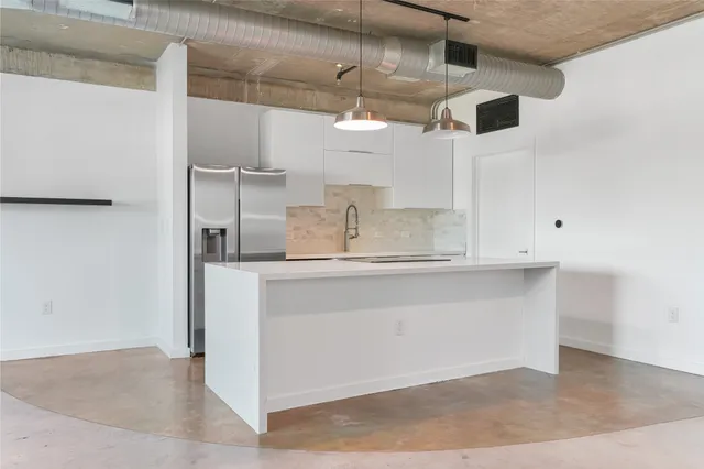 a kitchen with stainless steel appliances a sink and cabinets