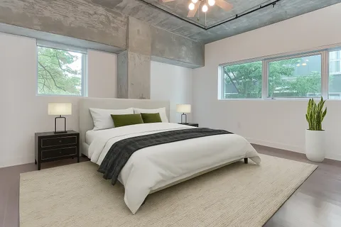 a bedroom with a bed lamp and window