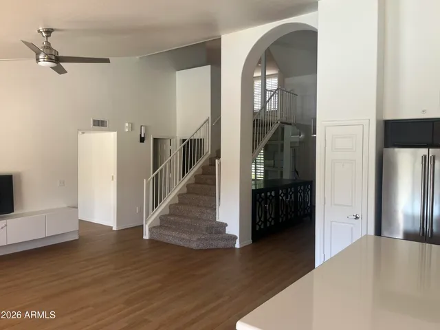 a view of a hallway view with wooden floor and staircase