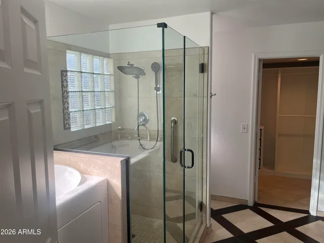 a bathroom with a shower and a sink