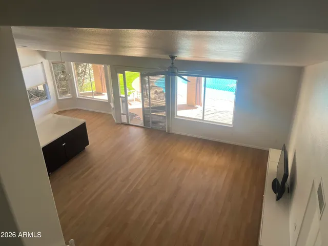 wooden floor in an empty room with a window
