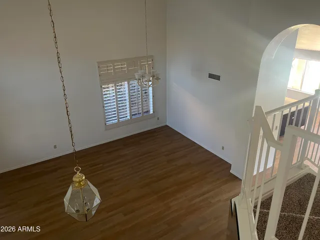 a room with wooden floor and windows