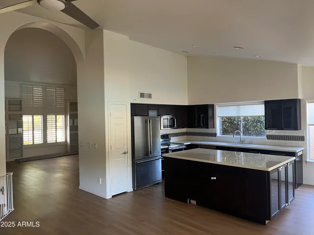 a kitchen with stainless steel appliances granite countertop a sink and a stove