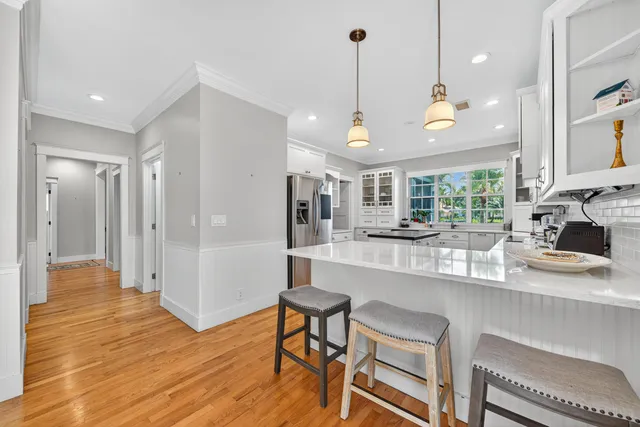 a large kitchen with a table and chairs