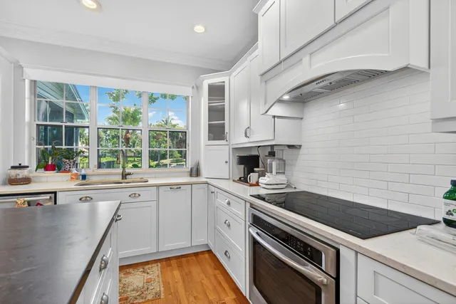 a kitchen with a sink stove and cabinets