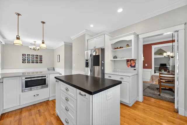a kitchen with granite countertop a sink and refrigerator