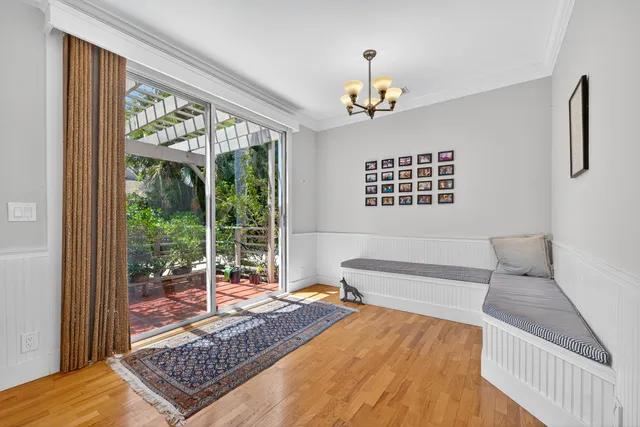 a living room with a bed furniture and a large window
