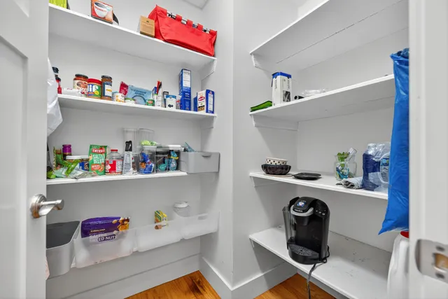 a kitchen with a refrigerator and a stove top oven