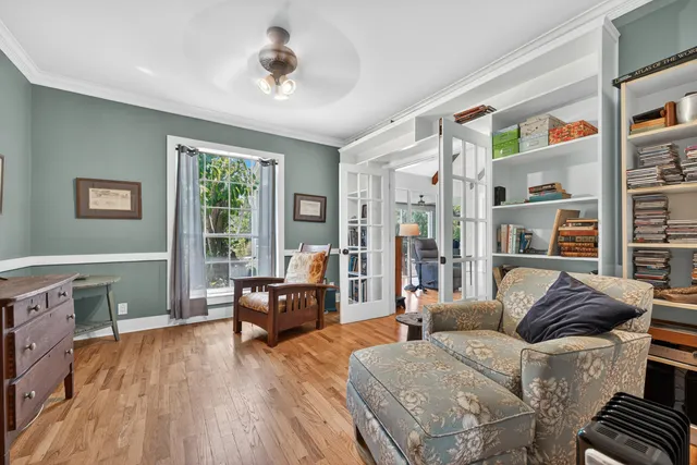 a living room with furniture and a wooden floor