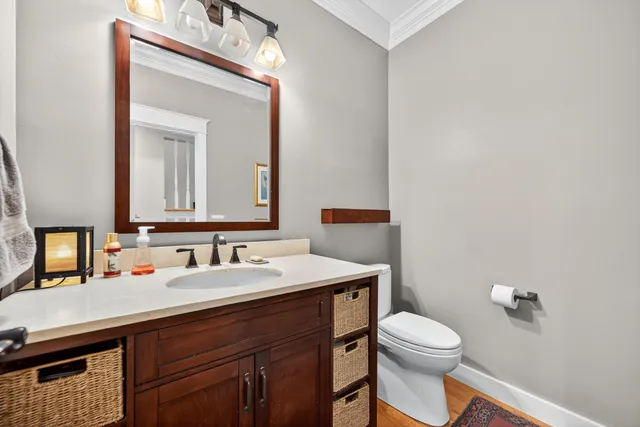 a bathroom with a toilet sink and mirror