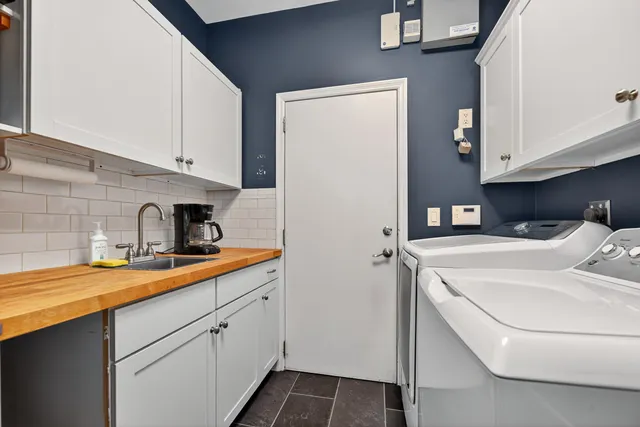 a kitchen with sink a refrigerator and cabinets