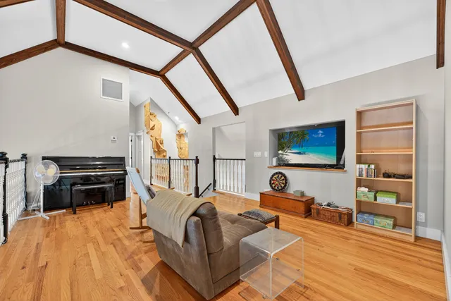 a bedroom with furniture and a flat screen tv