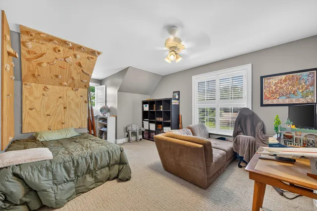 a bedroom with a bed couch and a window