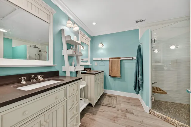 a bathroom with a granite countertop sink a toilet a mirror and shower