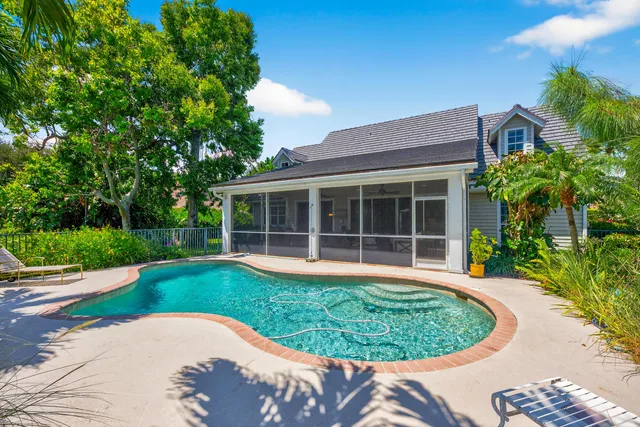 a view of a house with a backyard porch and sitting area