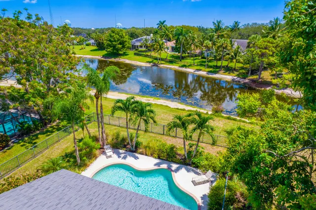 an aerial view of a house with a yard basket ball court and outdoor seating