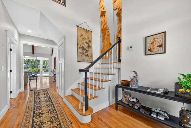 a living room with wooden floor and stairs
