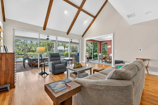 a living room with furniture and floor to ceiling window
