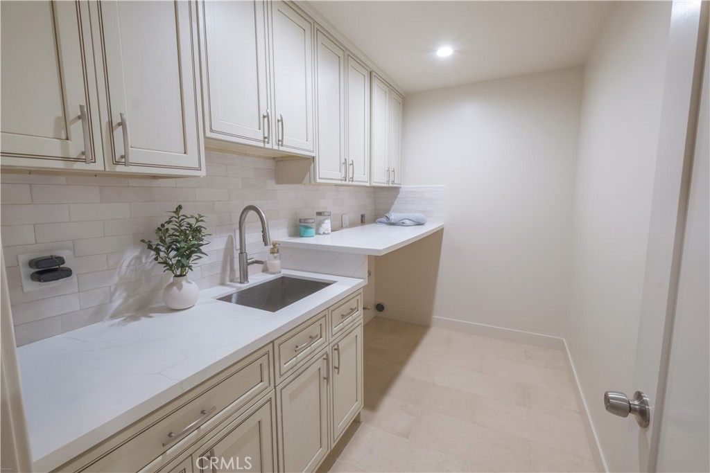 223 South Aprilia Avenue Compton, CA 90220 - Photo 20 of 46 a kitchen with stainless steel appliances granite countertop a sink and a white cabinets