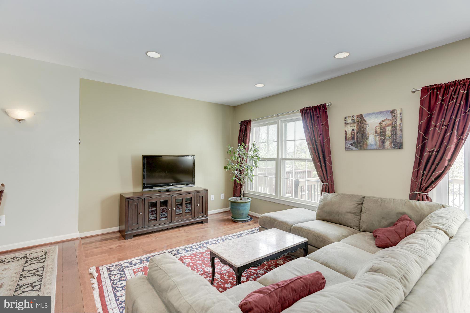 419 Davis Avenue Southwest Leesburg, VA 20175 - Photo 2 of 19 a living room with furniture and a flat screen tv