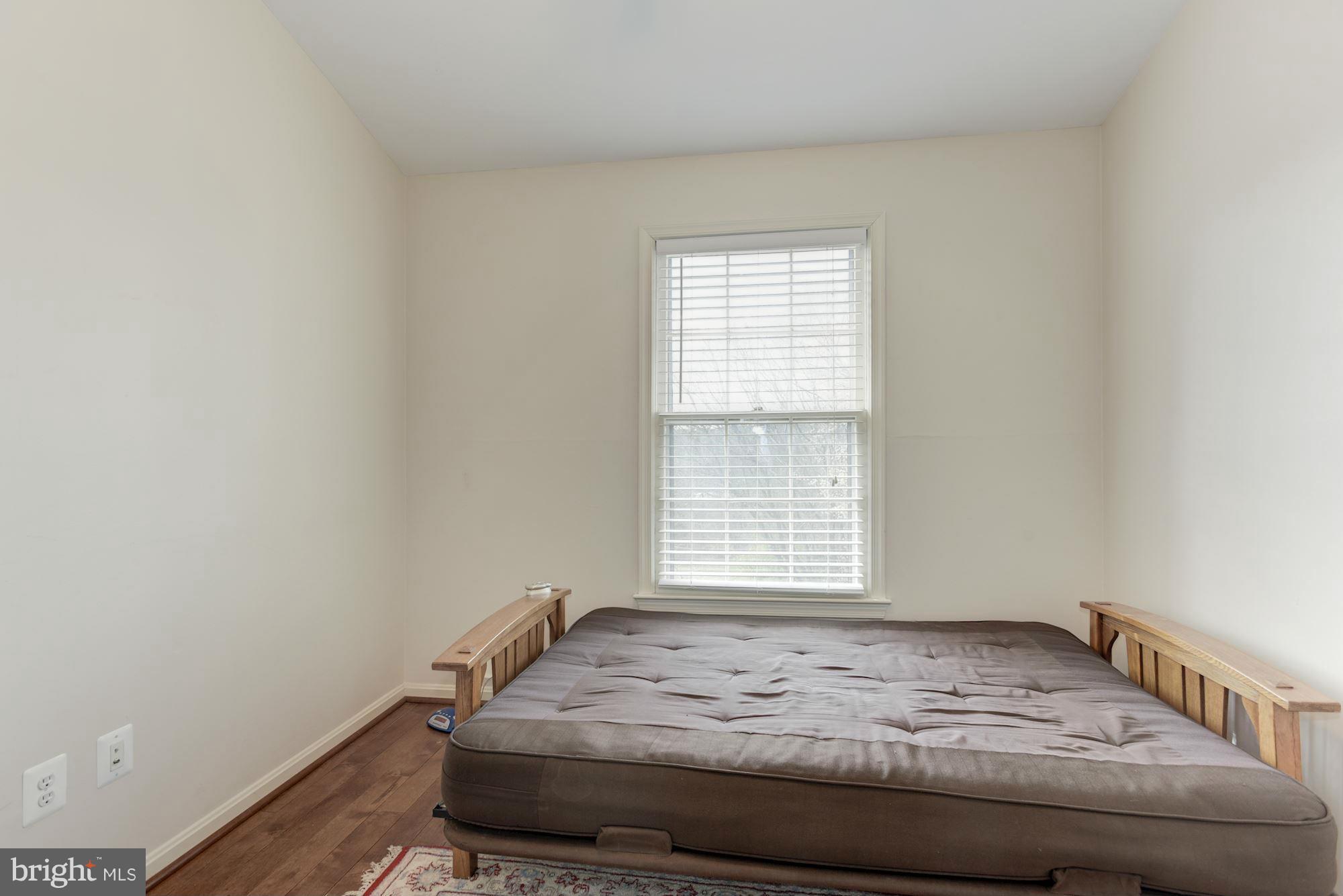 419 Davis Avenue Southwest Leesburg, VA 20175 - Photo 13 of 19 a bedroom with a bed and a window