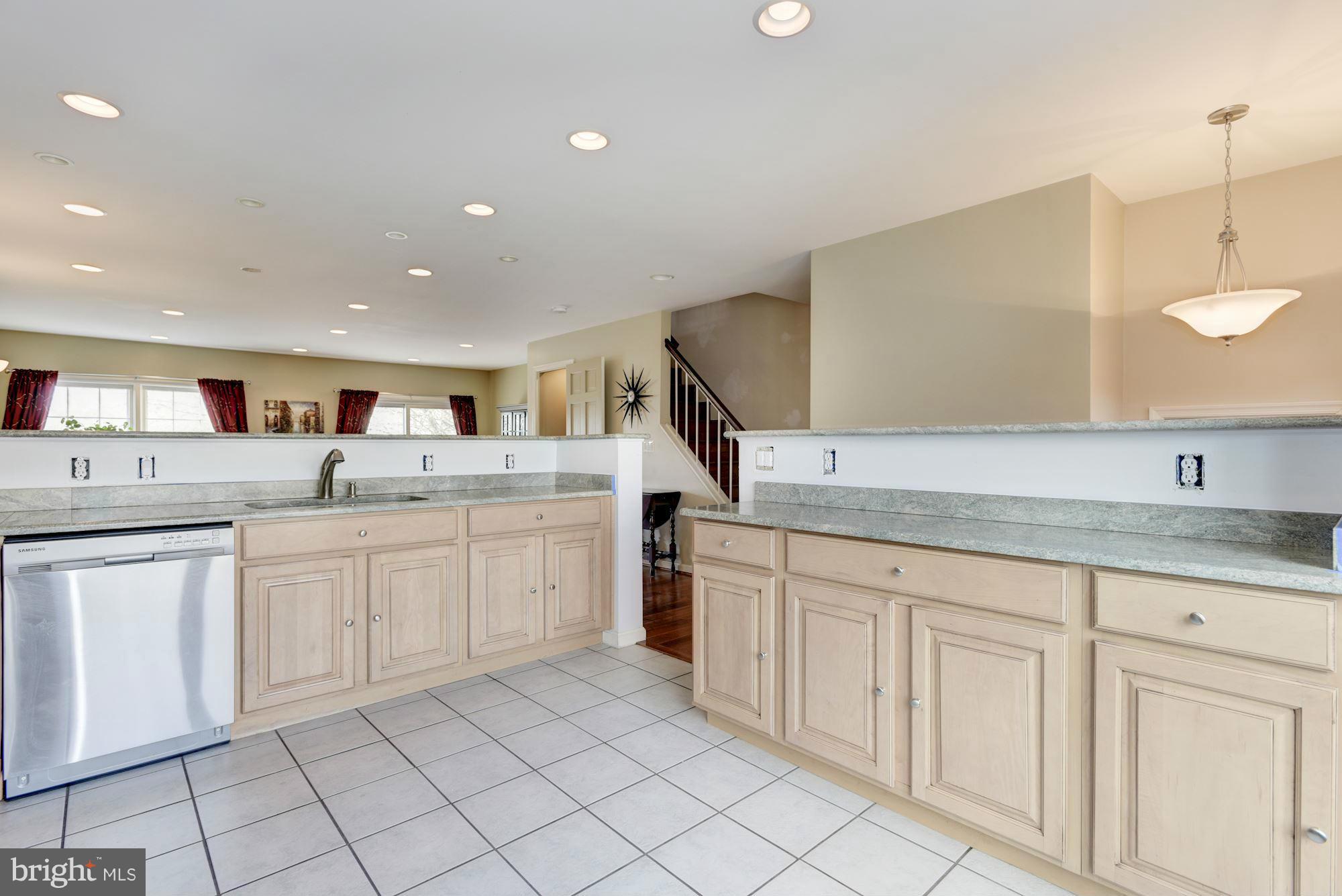 419 Davis Avenue Southwest Leesburg, VA 20175 - Photo 7 of 19 a kitchen with granite countertop white cabinets and white appliances