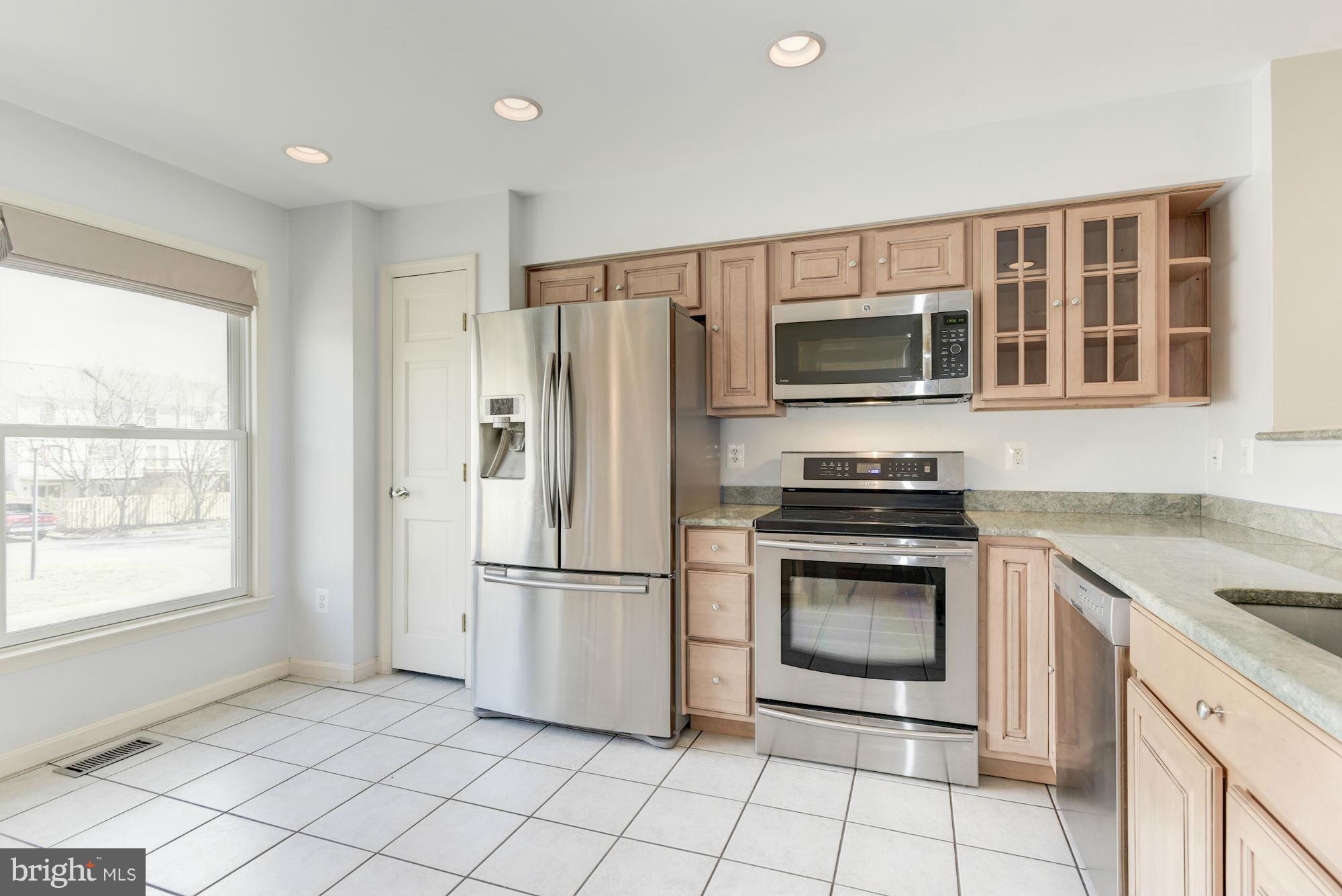 419 Davis Avenue Southwest Leesburg, VA 20175 - Photo 8 of 19 a kitchen with a refrigerator a stove a microwave and a window