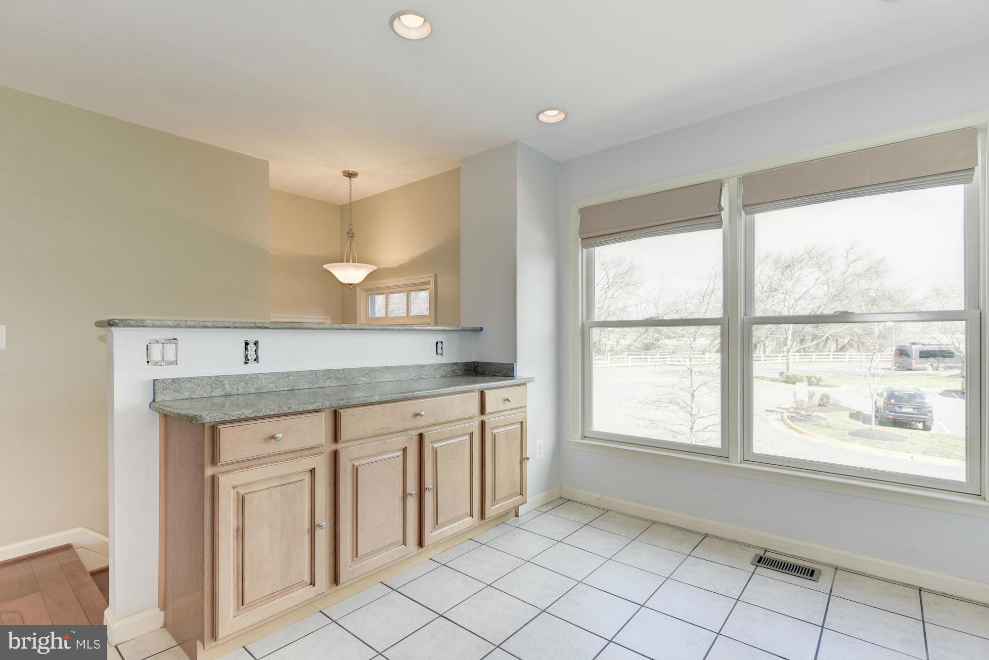 419 Davis Avenue Southwest Leesburg, VA 20175 - Photo 9 of 19 a view of an entryway with kitchen sink granite countertop cabinets and window