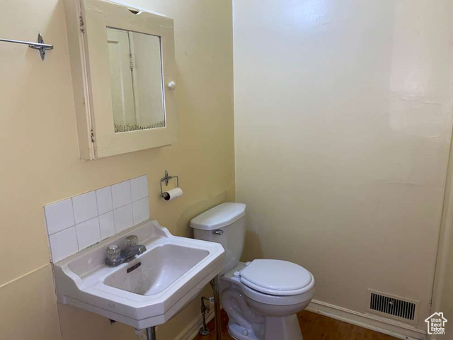 642 East 700 North Logan, UT 84321 - Photo 18 of 33 Half bathroom featuring toilet and wood finished floors