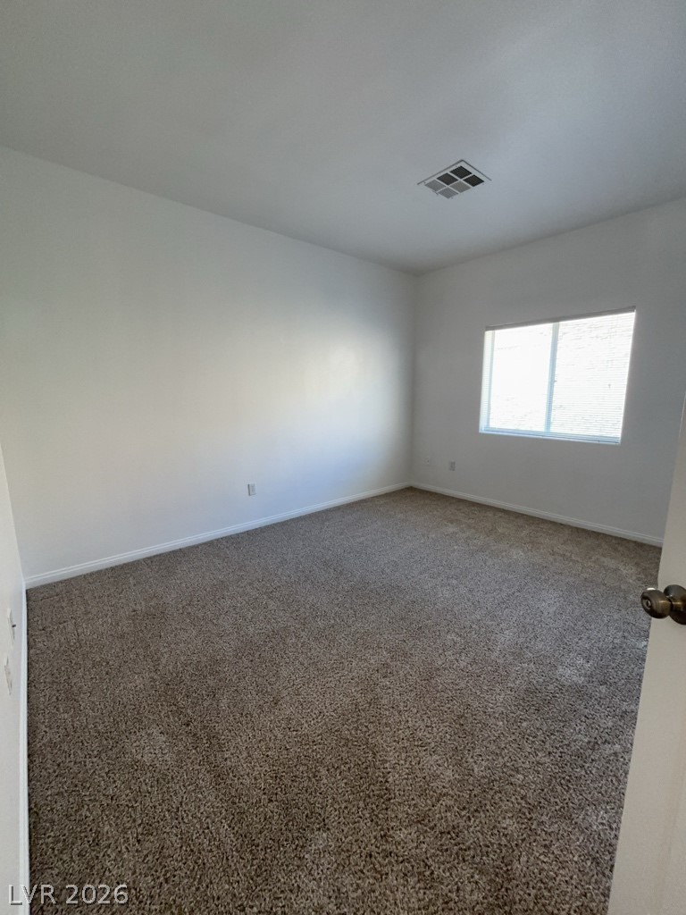 4915 East Russell Road, Unit 143 Las Vegas, NV 89120 - Photo 6 of 10 A well-lit bedroom features plush carpeting and a window for natural light.