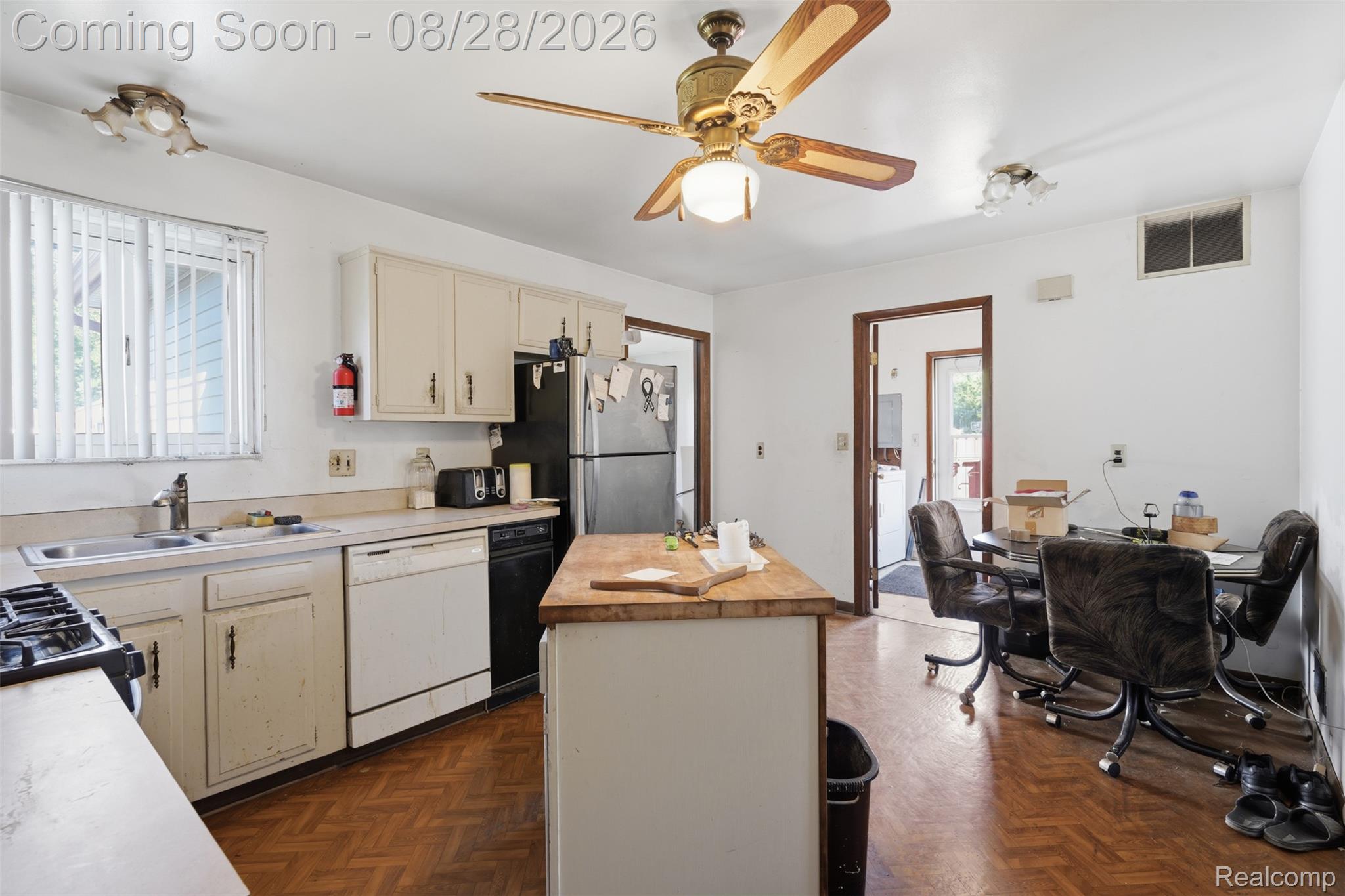 21353 Waltham Road Warren, MI 48089 - Photo 6 of 25 Kitchen featuring wood-finish flooring, white cabinetry, a kitchen island with a butcher block countertop, a gas range, and a ceiling fan