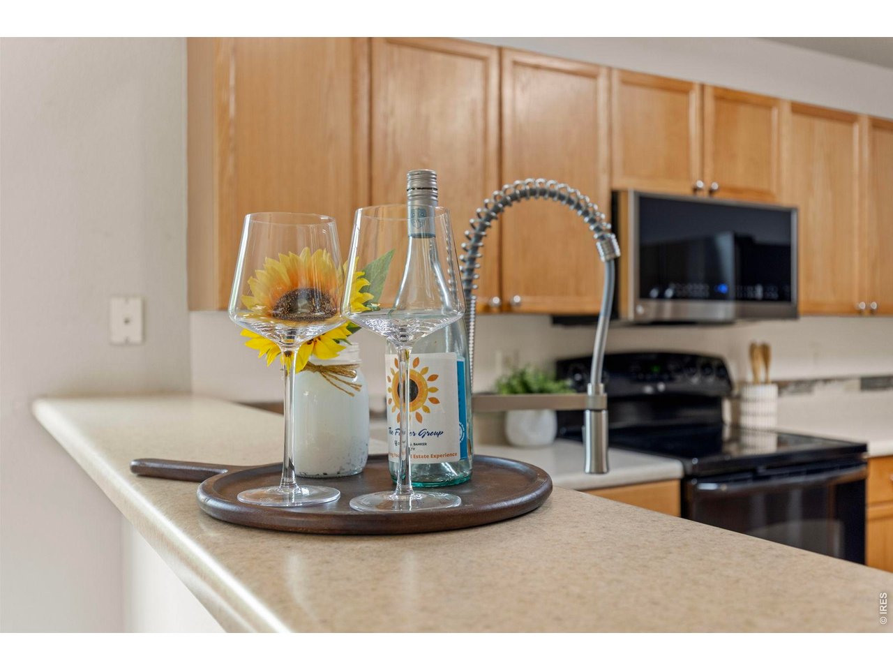 6531 St Vrain Ranch Boulevard Firestone, CO 80504 - Photo 11 of 30 a kitchen with a sink a stove and a microwave