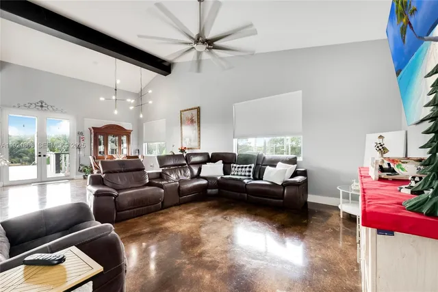 a view of a dining room with furniture a chandelier and wooden floor