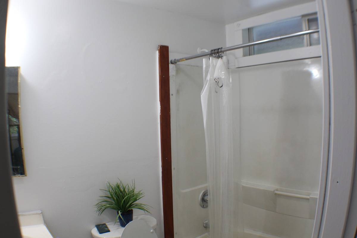 18-1248 Thorne Parkway Mountain View, HI 96771 - Photo 13 of 14 a bathroom with a glass shower door