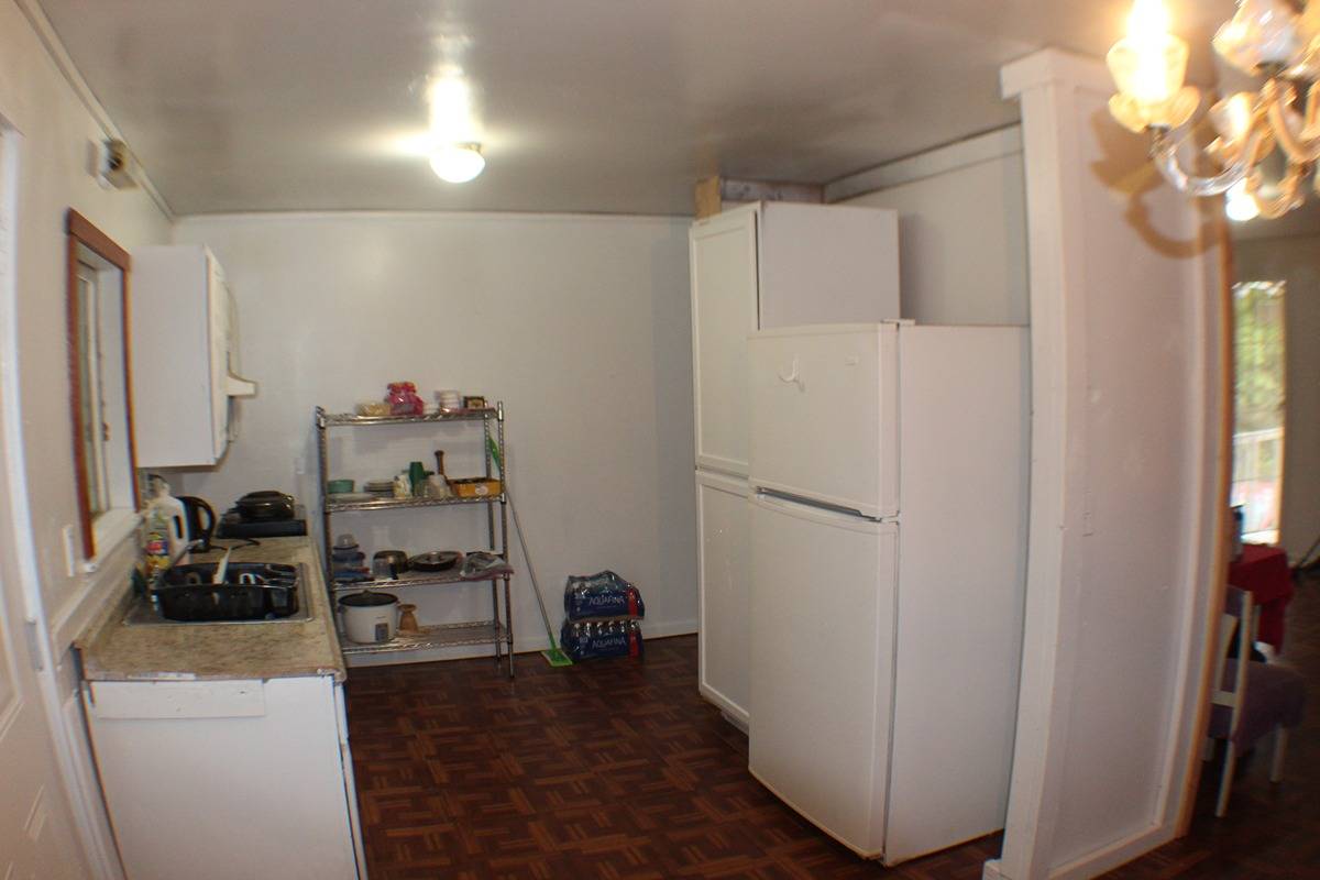 18-1248 Thorne Parkway Mountain View, HI 96771 - Photo 3 of 14 a kitchen with a refrigerator and a stove top oven