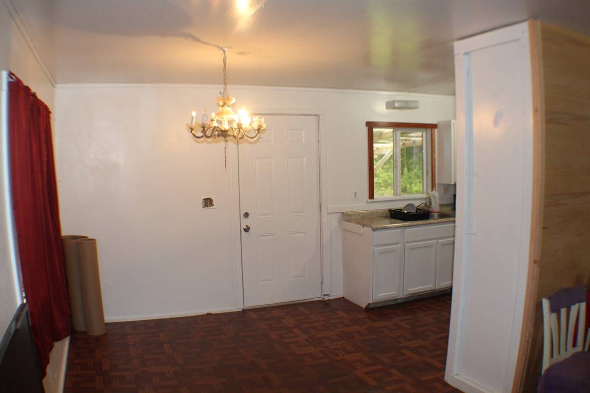 18-1248 Thorne Parkway Mountain View, HI 96771 - Photo 4 of 14 a room that has a lot of white cabinets and a chandelier