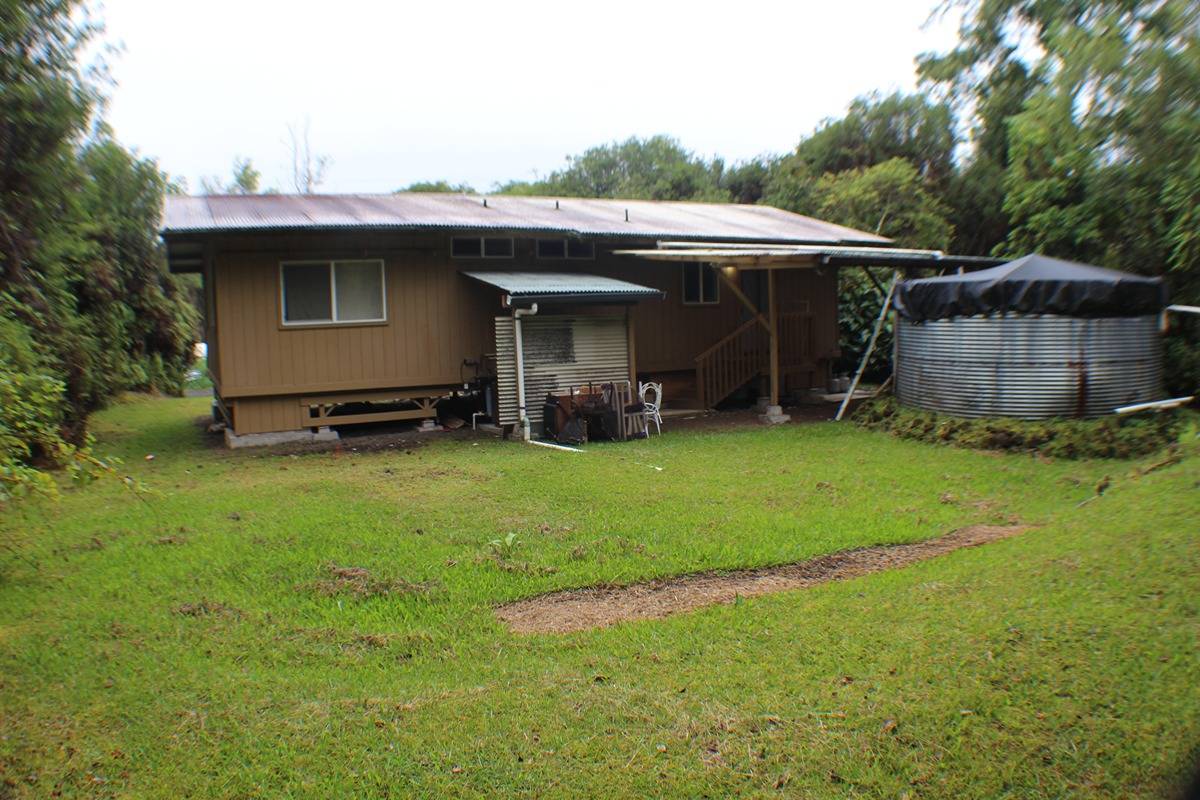 18-1248 Thorne Parkway Mountain View, HI 96771 - Photo 7 of 14 a view of a backyard with couches under an umbrella