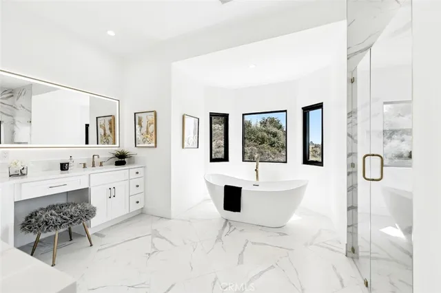 a bathroom with a shower sink and mirror