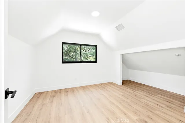 a view of a room with wooden floor