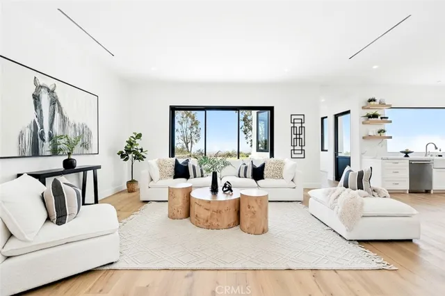 a living room with furniture and large windows