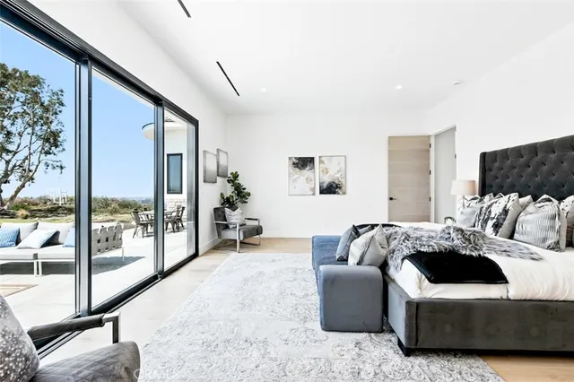 a large white bathroom with a sink mirror and a bathtub