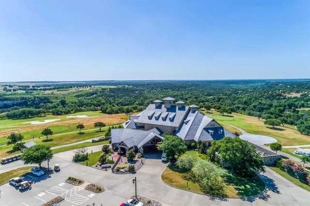 an aerial view of a house with garden space and ocean view
