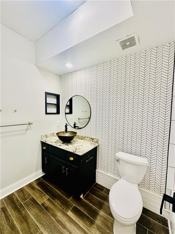 3777 Peachtree Road Northeast, Unit 1212 Atlanta, GA 30319 - Photo 16 of 25 a bathroom with a toilet a sink and mirror