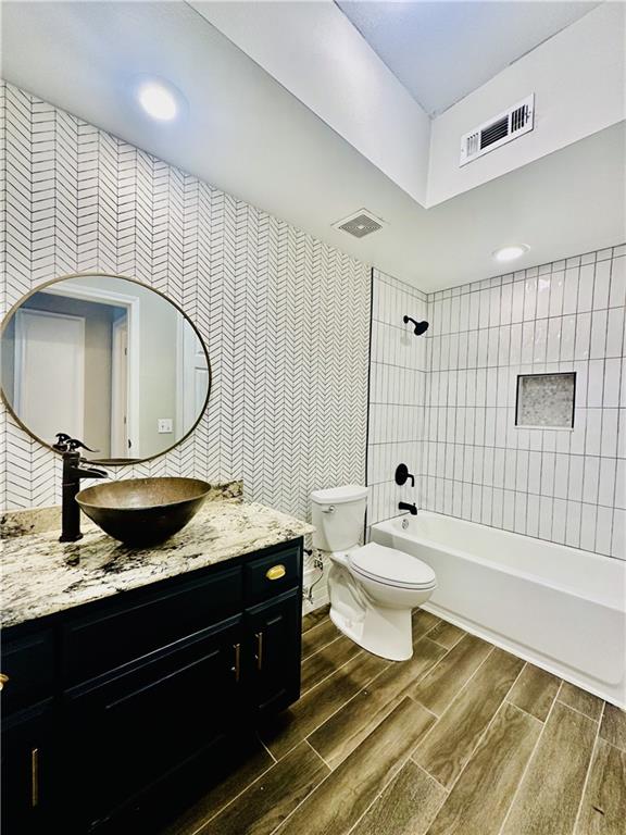 3777 Peachtree Road Northeast, Unit 1212 Atlanta, GA 30319 - Photo 17 of 25 a bathroom with a granite countertop sink and a mirror