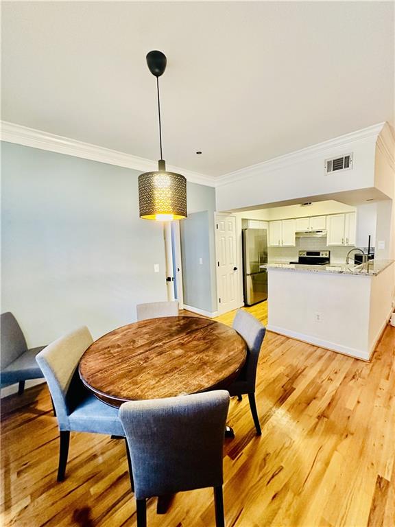 3777 Peachtree Road Northeast, Unit 1212 Atlanta, GA 30319 - Photo 7 of 25 a view of a dining room with furniture and wooden floor
